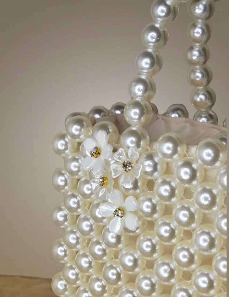 an elegant and luxurious handbag, fully crafted from shiny white pearl - 2